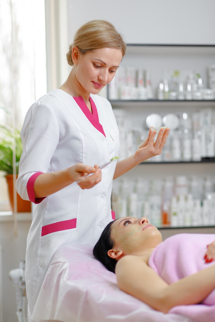 professional-woman-applying-green-cream-with-brush_1208-315